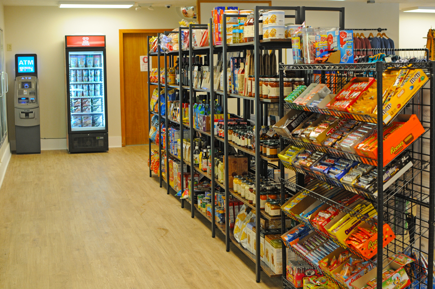 A picture of a shelving with a variety of food and snacks.